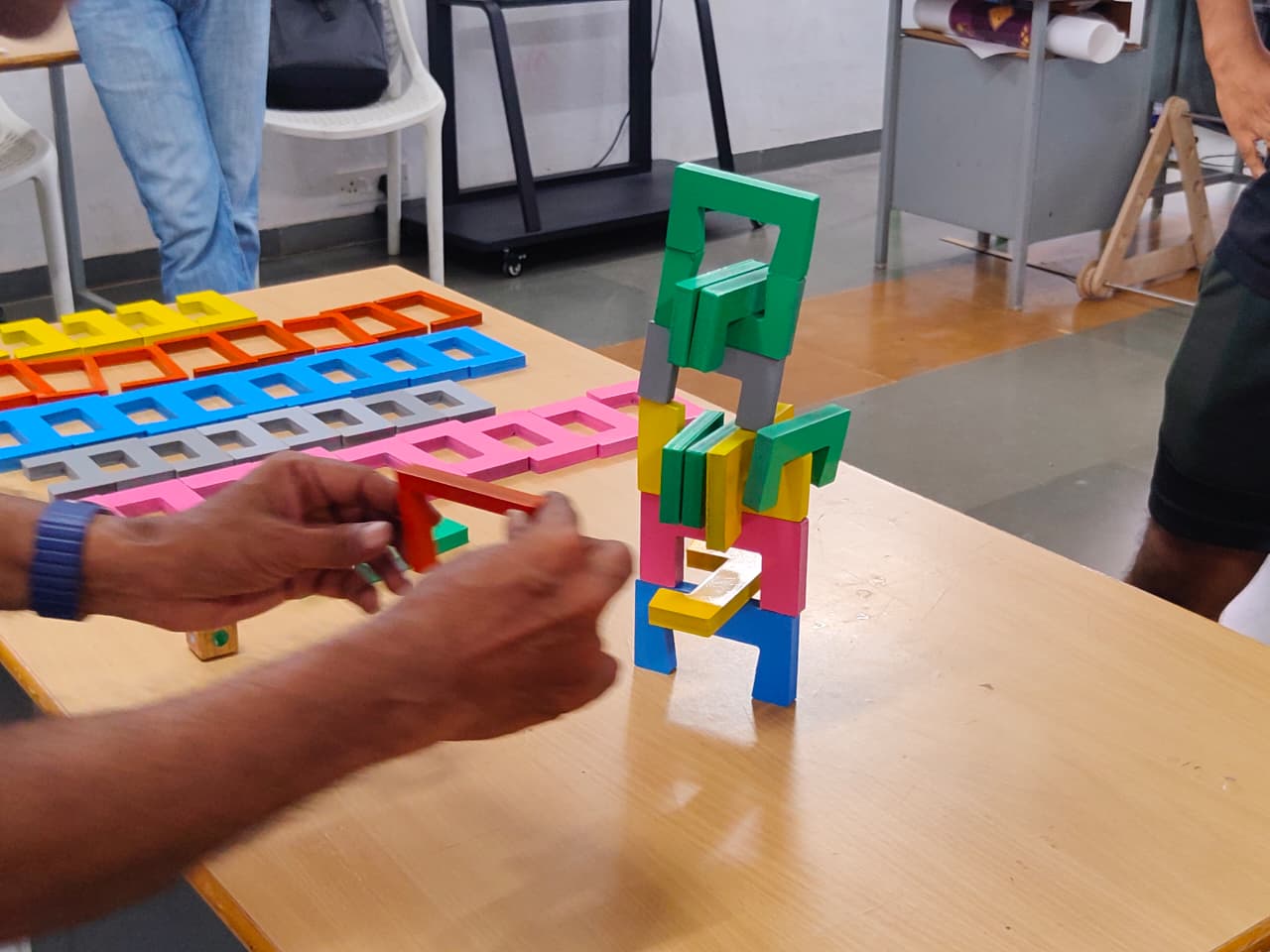 A tall tower of coloured staple forms mid game